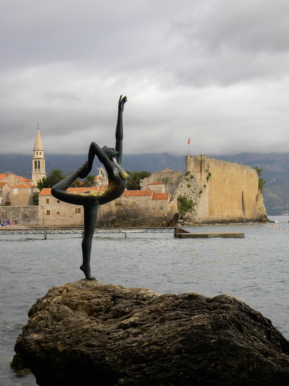 water, sea, coast, no one, travel, landscape, sky, outdoors, stone, beach, tourism, panoramic, nature, architecture, lighthouse, montenegro, budva, marina, bay, clouds, partly cloudy, travels, monument, mermaid, stroll, young woman, overcast sky